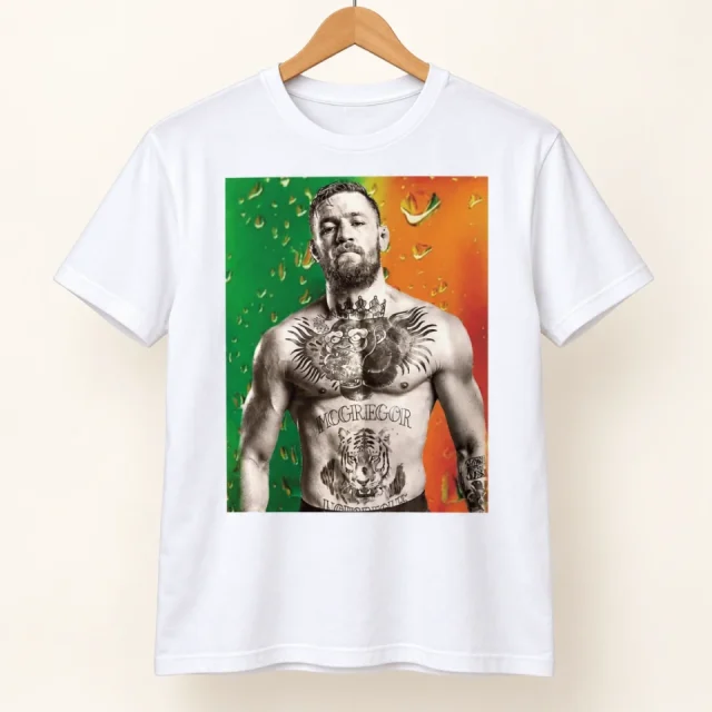 Studio view of a T-shirt with conor McGregor portrait against a green and orange background