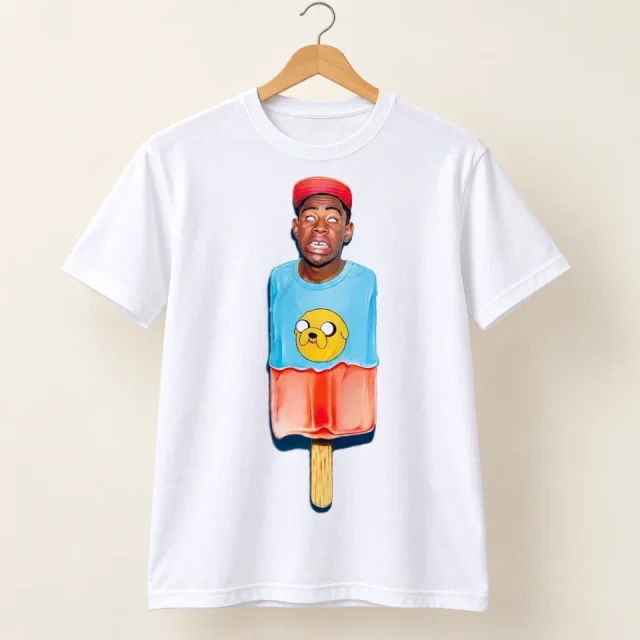 Studio view of a T-shirt with colourful portrait cartoon in an ice-lolly shape with a red cap