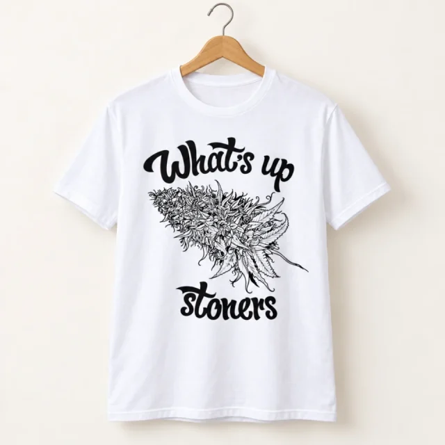 Studio view of a T-shirt with whats up Stoners lettering around a monochrome cannabis illustration